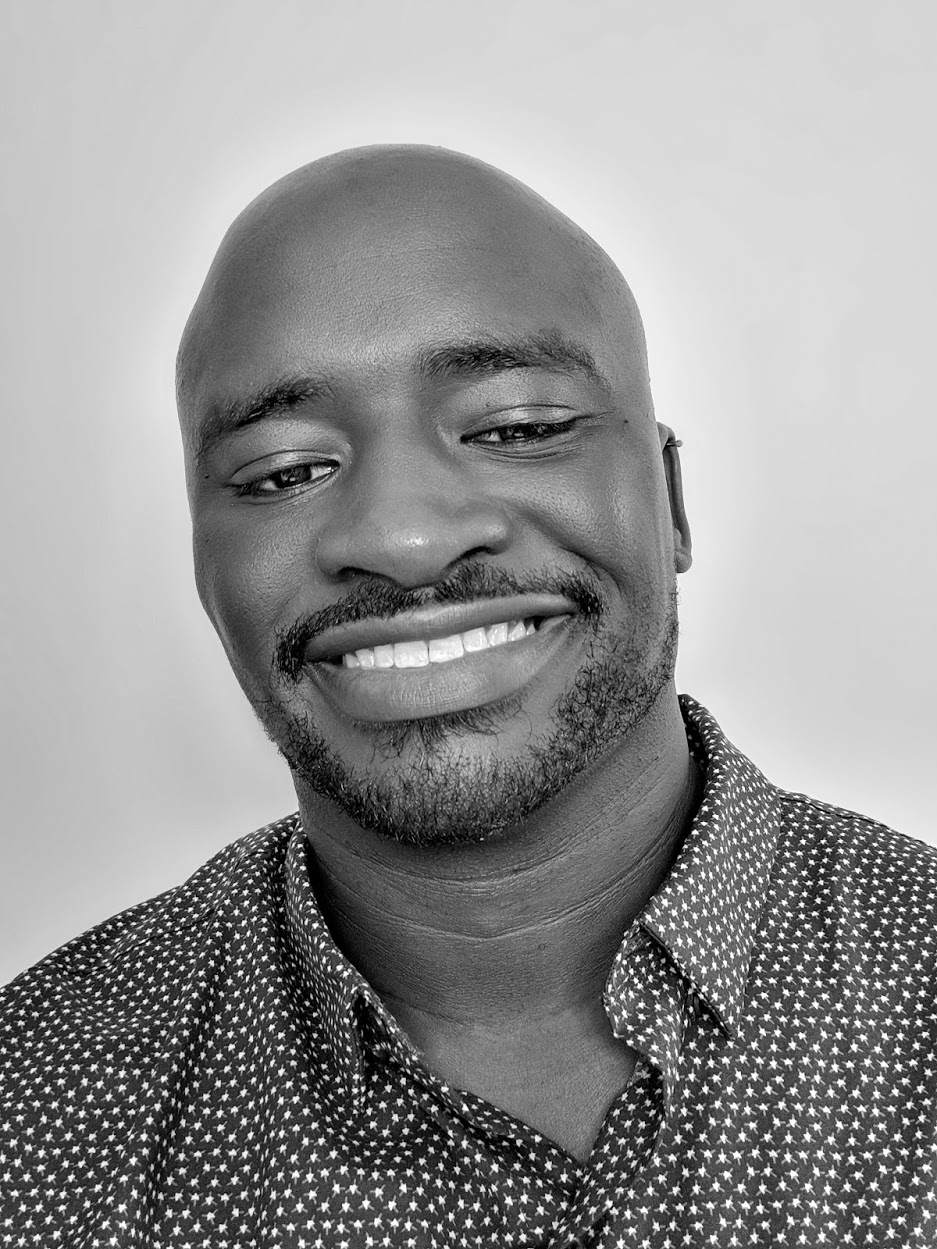 Gerald Onyango, smiling, head tilted, in a star-print shirt